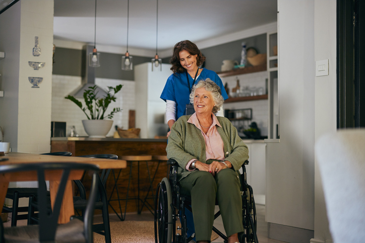 elderly women receiving help in her home provided by a home health care company