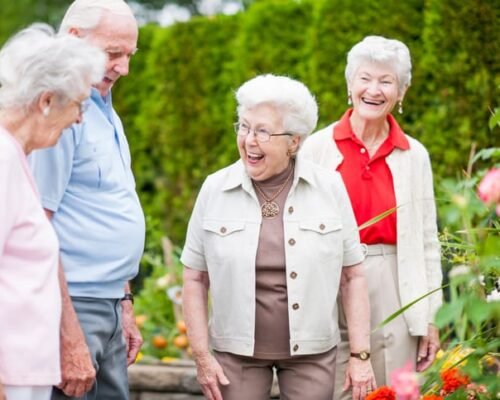 senior at an independent living facility walking outside by the garden